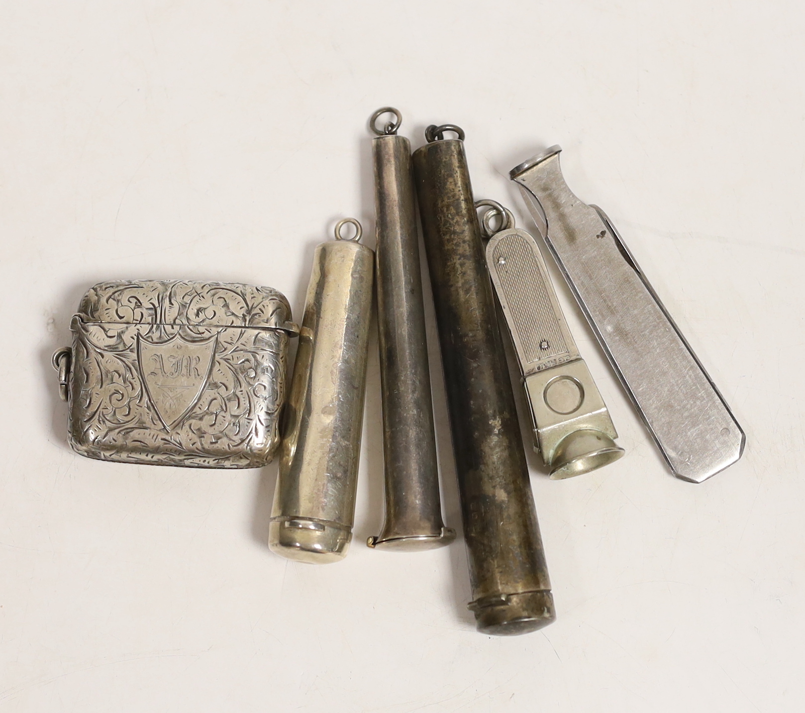 A late Victorian silver combination vesta case/cigar cutter, Birmingham, 1898, 46mm, three silver cheroot holder cases, a silver mounted cigar cutter and one other item.